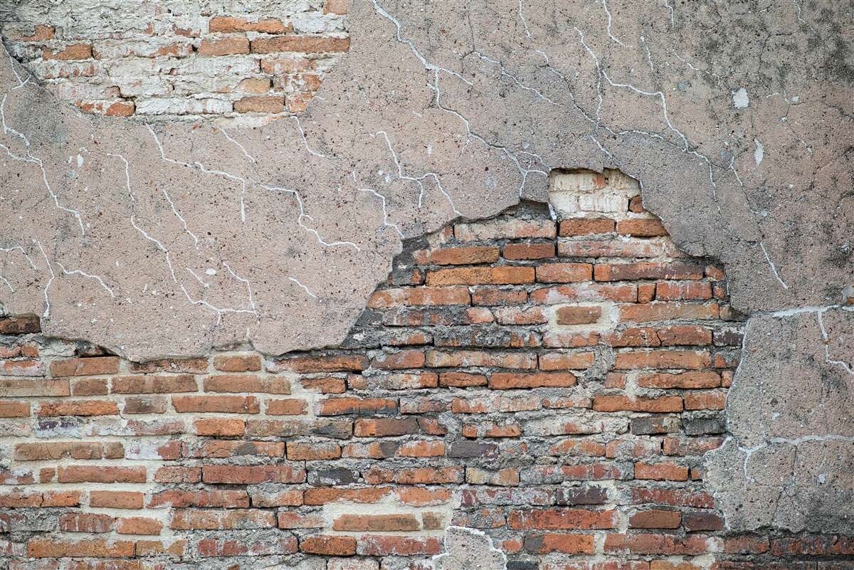 Papier peint Un mur de briques qui s'effondre