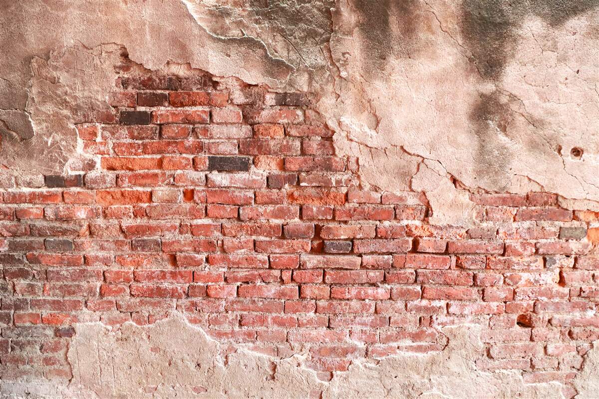 Papier peint Mur recouvert de briques effritées