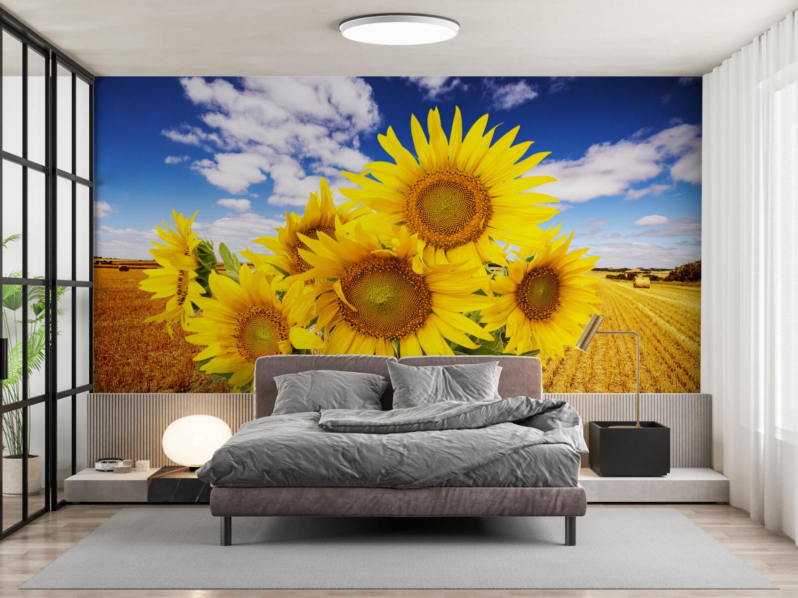 Papier peint un bouquet de tournesols se détache sur le ciel et un champ de blé